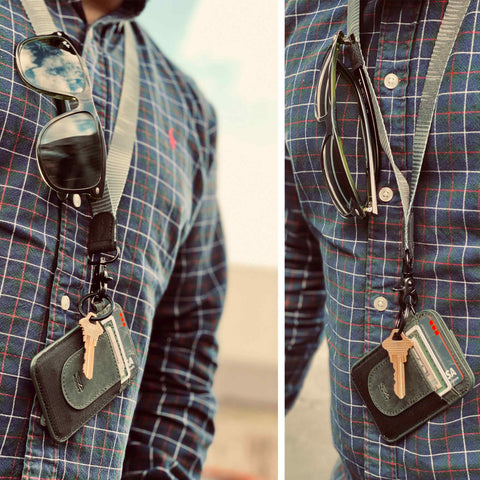 Green neck lanyard with wallet keys and sunglasses man showing carry feature of lanyard