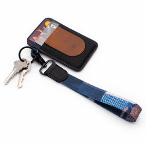 Multi color navy orange wrist lanyard with keychain keys and brown slim wallet