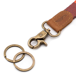 Close up lanyard with 2 metal key rings brown leather orange striped fabric