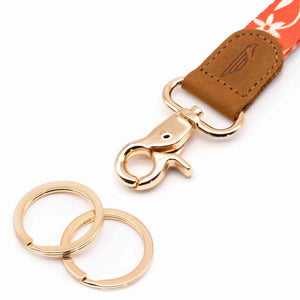 Close up lanyard with 2 gold metal key rings brown leather orange color fabric