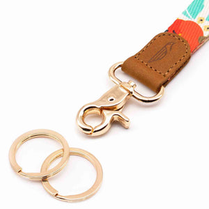 Close up lanyard with 2 gold metal key rings brown leather red blue fabric